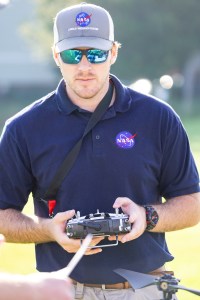 Brayden Chamberlain, UAS Pilot in Command, uses a remote control transmitter to pilot the NASA Alta X uncrewed aerial system (UAS) during NASA FireSense’s UAS technology demonstration in Missoula, Montana.
