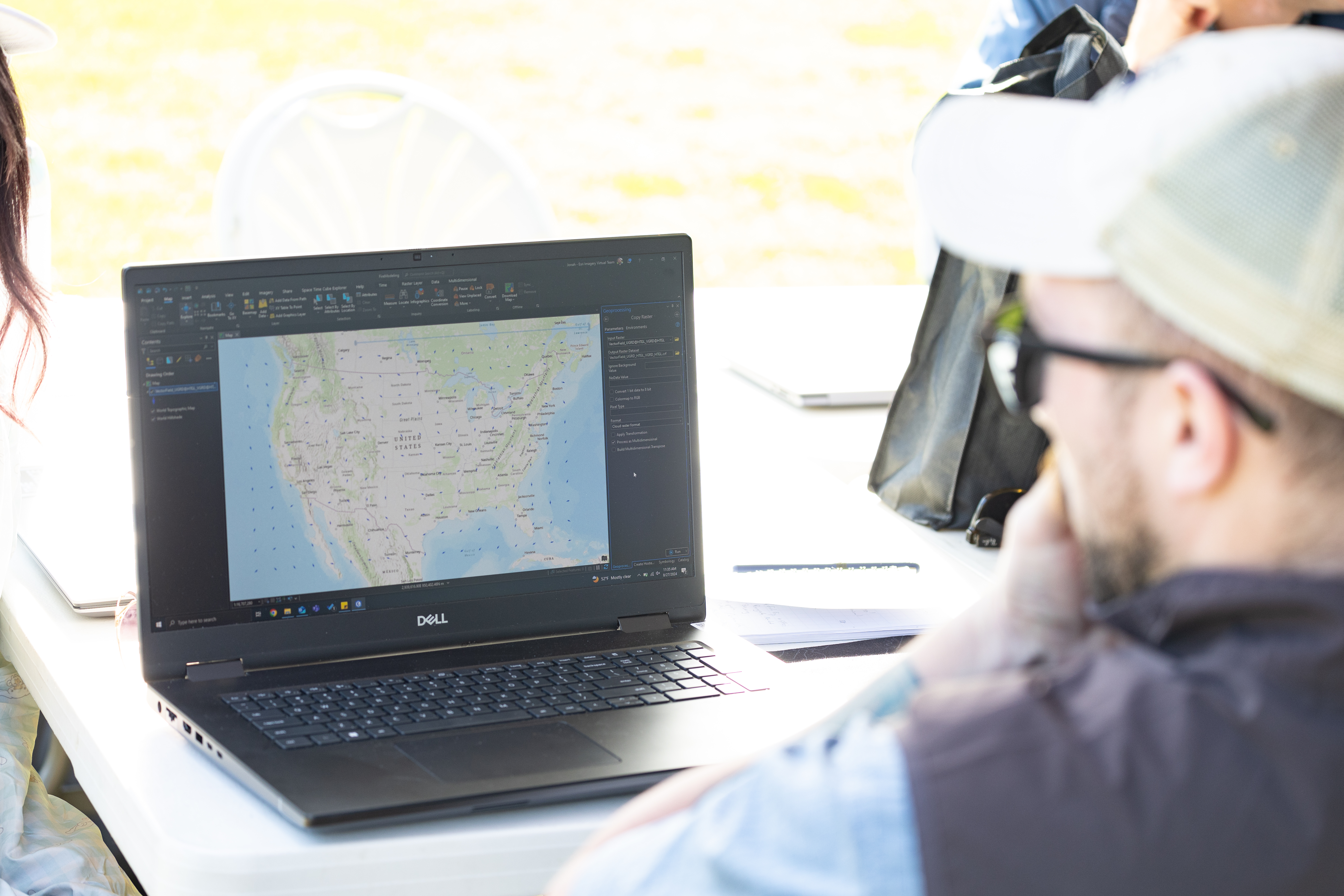 Jonah Hall, data visualizer at MITRE, looks at a wind surface model that forecasts surface winds at a national scale. This baseline is an important piece of the MITRE team’s goal to create dynamic data visualizations of the wind data gathered throughout the FireSense uncrewed aerial system (UAS) technology demonstration in Missoula, Montana.