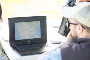 Jonah Hall, data visualizer at MITRE, looks at a wind surface model that forecasts surface winds at a national scale. This baseline is an important piece of the MITRE team’s goal to create dynamic data visualizations of the wind data gathered throughout the FireSense uncrewed aerial system (UAS) technology demonstration in Missoula, Montana.