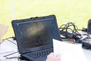 Jacob Revesz, uncrewed aerial system (UAS) Ground Station Operator, holds a preflight checklist while looking over the flight plan (green line) for the next launch of the NASA Alta X quadcopter. Revesz is part of the NASA Langley UAS team, which flew multiple aircraft during the 2024 FireSense UAS technology demonstration in Missoula, Montana.
