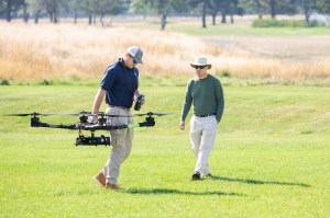 Brayden Chamberlain, UAS Pilot in Command, carries the NASA Alta X quadcopter during pre-flight calibrations ahead of the drone’s first flight for FireSense’s uncrewed aerial system (UAS) technology demonstration in Missoula, Montana.