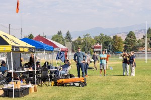 A field crew from MITRE, Esri, NASA, the University of Idaho, and Salish Kootenai College watch the NASA Alta X quadcopter rise into the air for its first flight of the FireSense uncrewed aerial system (UAS) technology demonstration in Missoula, Montana.