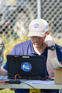 Jacob Revesz, UAS Ground Station Operator, tracks the flight progress of the Alta X quadcopter on its first flight for the FireSense uncrewed aerial system (UAS) technology demonstration in Missoula, Montana.