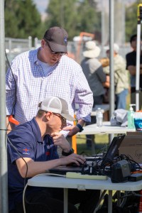 Jacob Revesz, UAS Ground Station Operator, tracks the flight progress of the Alta X quadcopter while Robert McSwain, FireSense UAS Lead at NASA Langley, looks on. This was one of eight launches the team performed during the August FireSense UAS Technology Demonstration in Missoula, Montana.