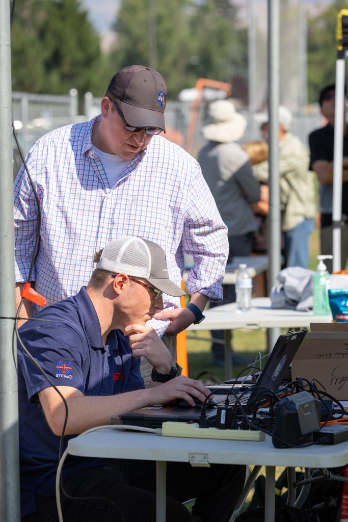 Jacob Revesz, UAS Ground Station Operator, tracks the flight progress of the Alta X quadcopter while Robert McSwain, FireSense UAS Lead at NASA Langley, looks on. This was one of eight launches the team performed during the August FireSense UAS Technology Demonstration in Missoula, Montana.