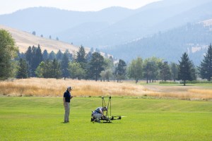 UAS Pilot in Command Brayden Chamberlain (left) and mechanical engineer Todd Ferrante (right) perform final checks on the NASA Alta X quadcopter before a launch, during the FireSense uncrewed aerial system (UAS) technology demonstration in Missoula, Montana.