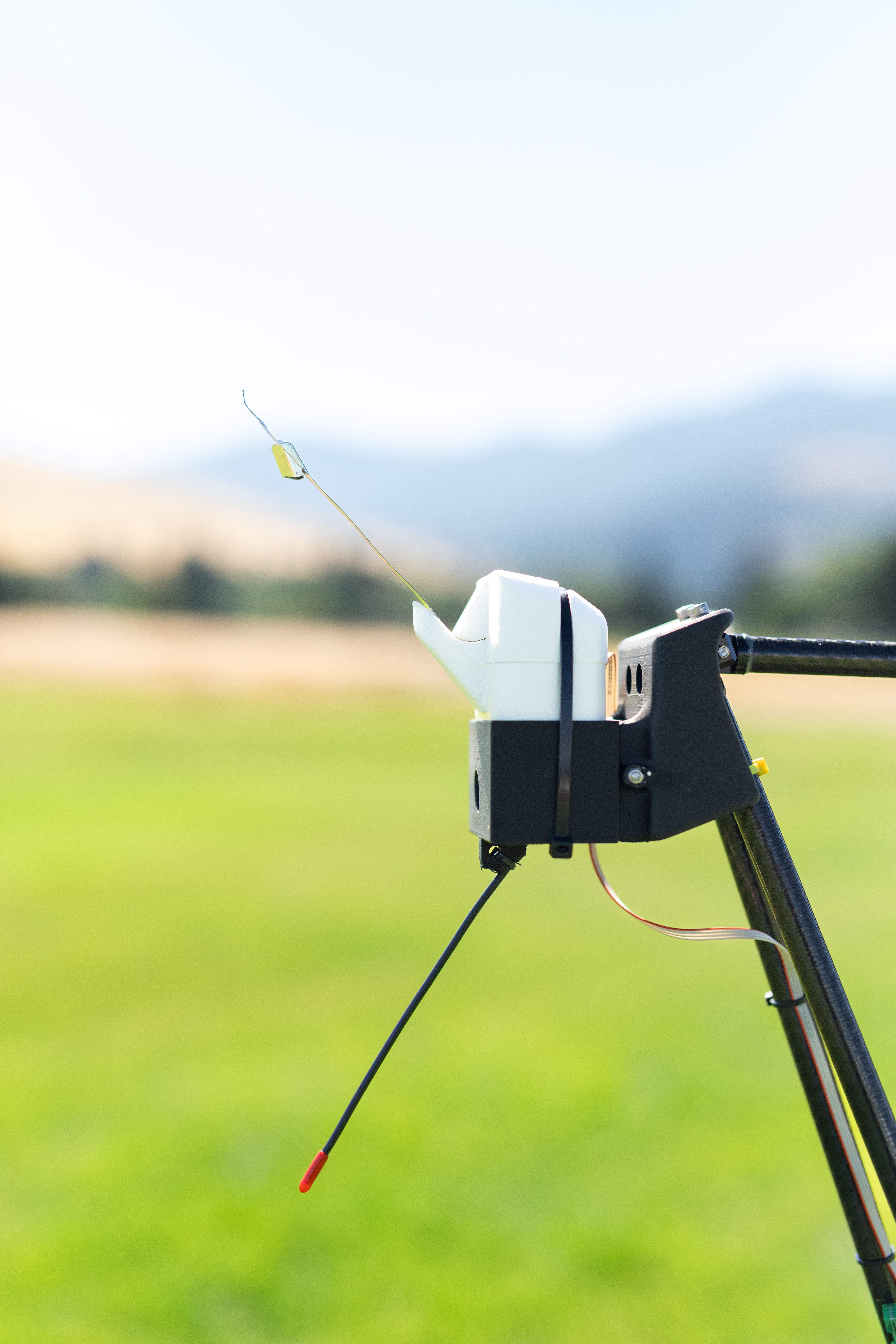 The radiosonde is one of two sensors mounted on the NASA Alta X quadcopter during the FireSense uncrewed aerial system (UAS) technology demonstration in Missoula, Montana. These two sensors measure wind speed and direction; the FireSense teams hopes that by giving them wings, researchers can enable micrometeorology to better predict fire and smoke behavior.