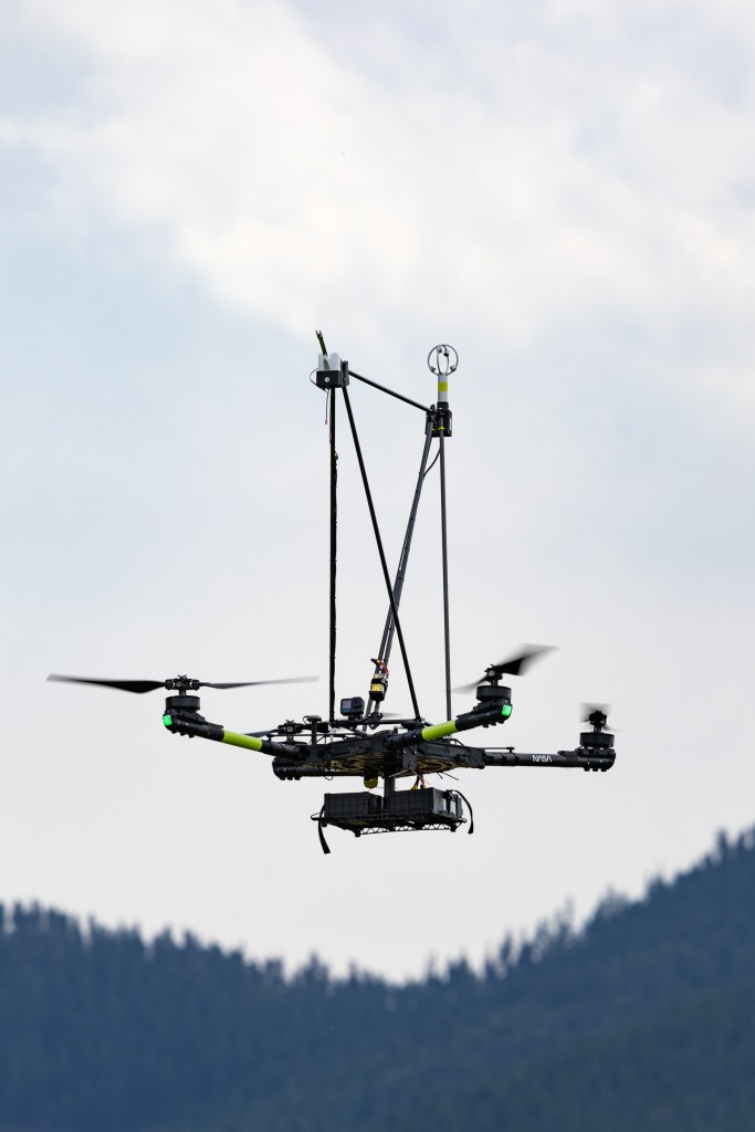 The NASA Alta X quadcopter descends over the mountains during one of eight launches for the FireSense uncrewed aerial system (UAS) Technology Demonstration in Missoula, Montana.