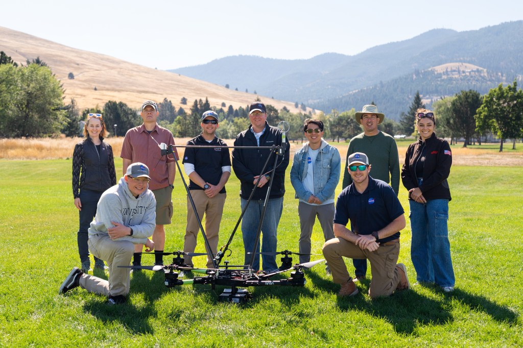 The NASA team deployed for the August 2024 FireSense field campaign in Missoula, Montana, stands in a field with the NASA Alta X quadcopter. The campaign involved members of the FireSense Project Office, the NASA Langley drone team, logistics support from the Earth Science Project Office, and communications from NASA Ames Earth Science Division. (Not pictured: NASA FireSense Project Manager Jennifer Fowler, also present for the campaign).