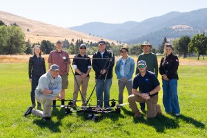 The NASA team deployed for the August 2024 FireSense field campaign in Missoula, Montana, stands in a field with the NASA Alta X quadcopter. The campaign involved members of the FireSense Project Office, the NASA Langley drone team, logistics support from the Earth Science Project Office, and communications from NASA Ames Earth Science Division. (Not pictured: NASA FireSense Project Manager Jennifer Fowler, also present for the campaign).