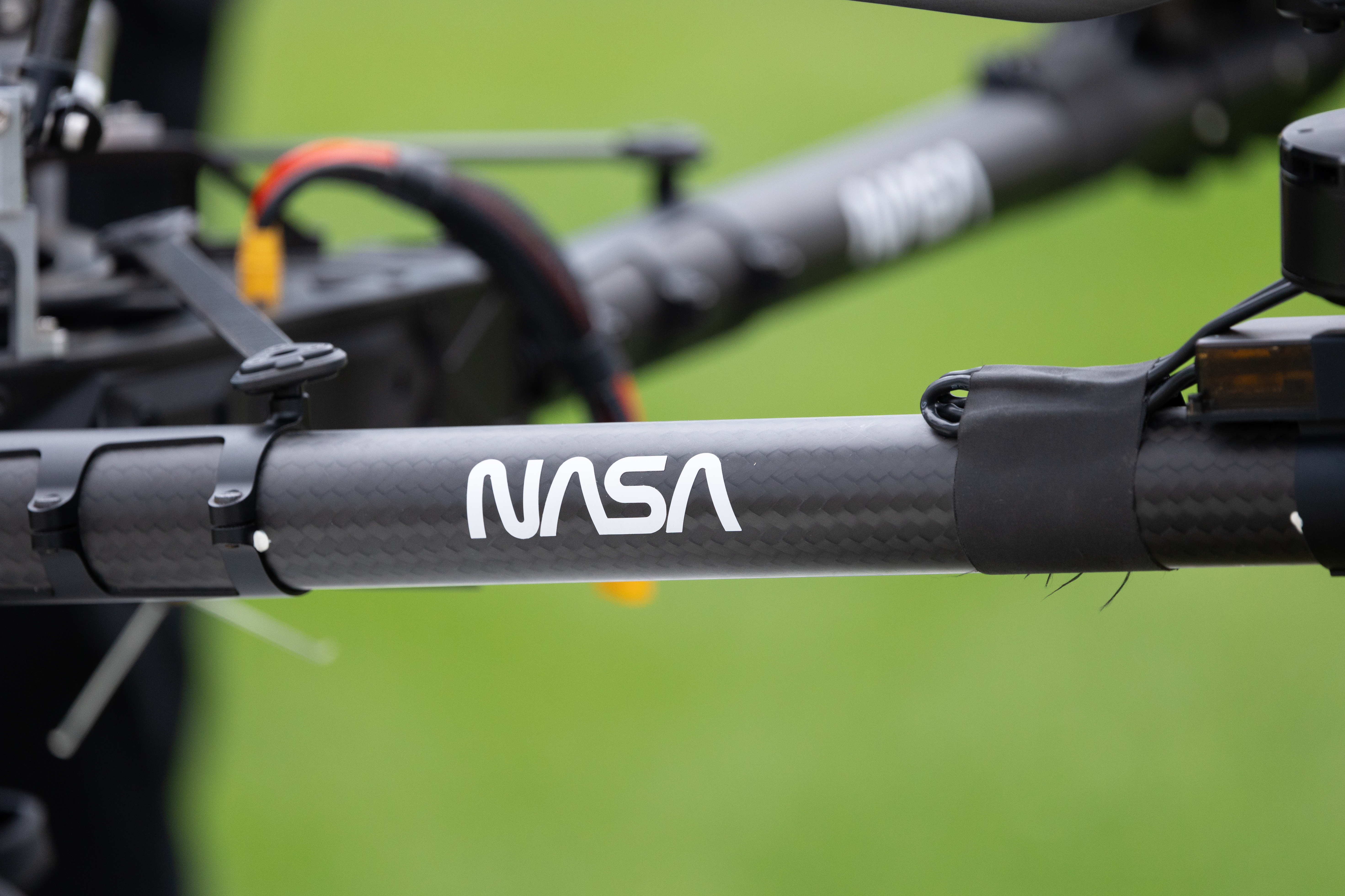 The iconic NASA worm logo sits on the arm of the Alta X quadcopter as it sits at the ready between launches. This uncrewed aerial system (UAS) carried two sensors, a radiosonde and an anemometer, to measure wind speed and direction during the 2024 FireSense UAS technology demonstration.