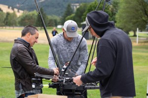 NASA Langley drone team members (from left) Todd Ferrante, Brayden Chamberlain, and Jacob Revesz check the NASA Alta X quadcopter between launches during the FireSense uncrewed aerial system (UAS) Technology Demonstration in Missoula, Montana.
