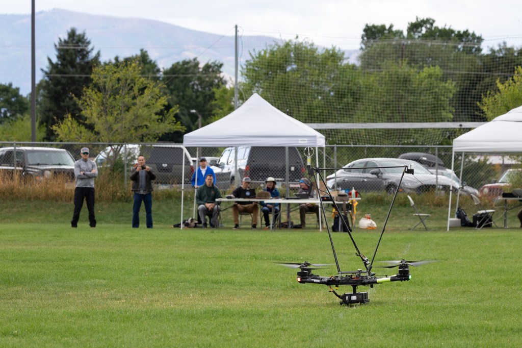 A group of NASA researchers, pilots, and engineers watch as the NASA Alta X gears up for takeoff in one of the final launches of the 2024 FireSense uncrewed aerial system (UAS) technology demonstration in Missoula, Montana.