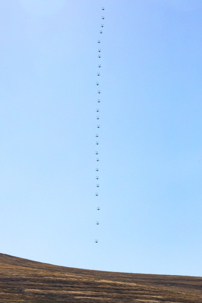 A composite image shows the flight path of the NASA Alta X quadcopter as it performs a ‘vertical sounding,’ flying low to the ground then straight up into the air to collect data in a vertical column.