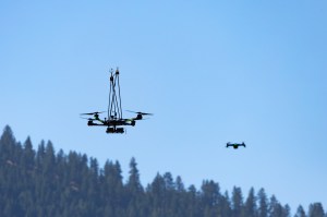 The NASA Alta X quadcopter and the Skydio-2 drone hover over the mountain during the final flight of the FireSense uncrewed aerial system (UAS) technology demonstration in Missoula, Montana.
