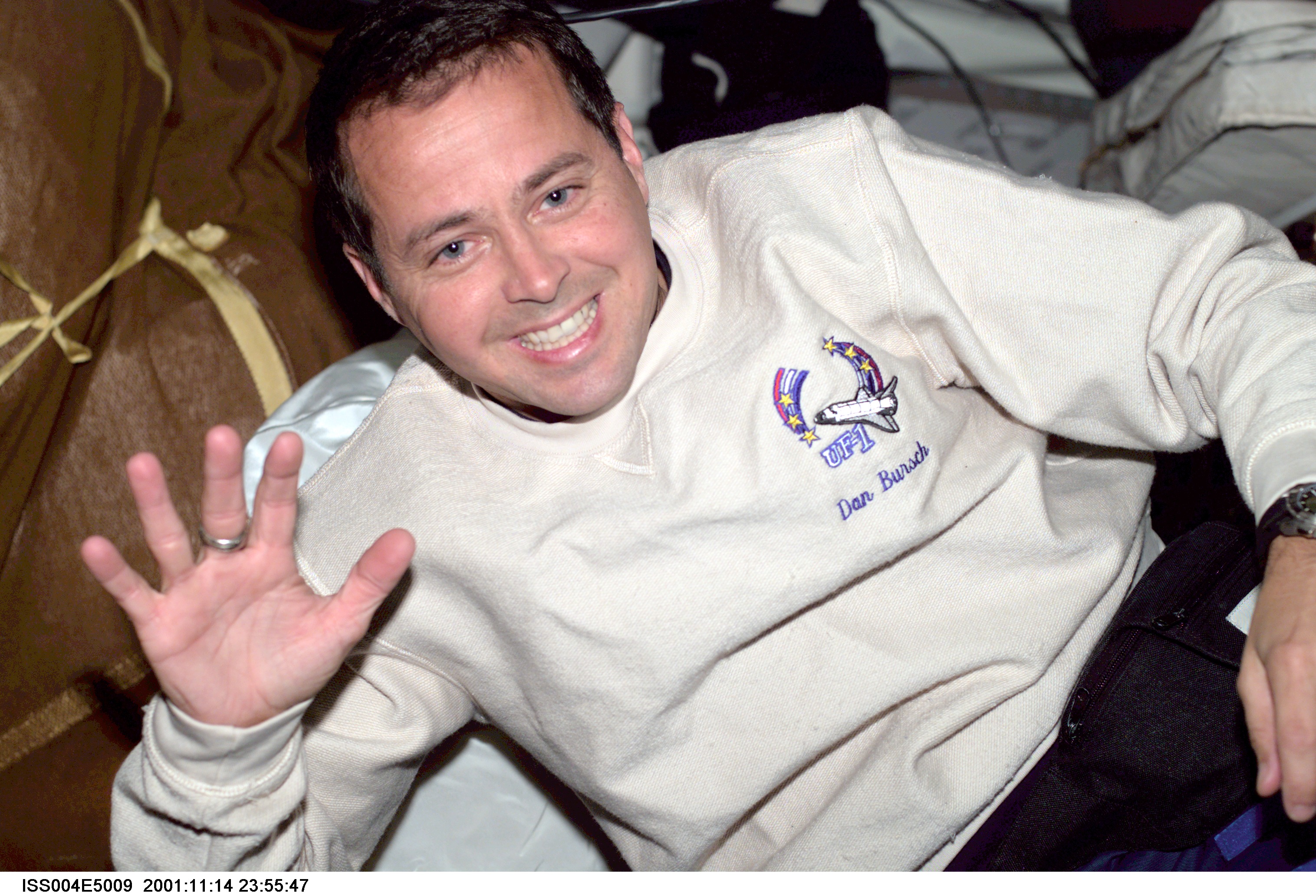 ISS004-E-5009 (December 2001) --- Astronaut Daniel W. Bursch, Expedition Four flight engineer, is photographed with stowage bags on the mid deck of...