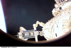 ISS004-E-5026 (15 December 2001) --- As seen through a window on the International Space Station (ISS), the Space Shuttle Endeavour is photographed as it undocks from the station. A portion of the Canadarm2 is visible in the foreground. The image was taken with at digital still camera.