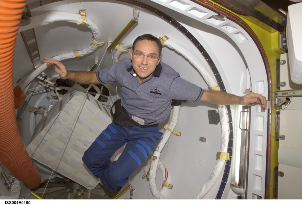 ISS004-E-5190 (December 2001) --- Astronaut Carl E. Walz, Expedition Four flight engineer, floats in the Quest Airlock on the International Space Station (ISS). The image was taken with a digital still camera during early phase of the three-person crew’s scheduled stay on the orbital outpost.