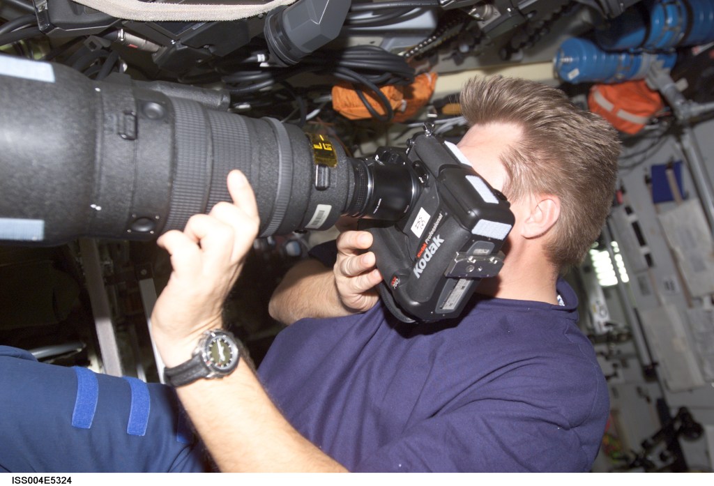 ISS004-E-5324 (December 2001) --- Cosmonaut Yuri I. Onufrienko, Expedition Four mission commander representing Rosaviakosmos, takes Earth observation photos with an electronic still camera equipped with an 800mm lens. Onufrienko is in the Zvezda Service Module on the International Space Station (ISS). The image was taken with a digital still camera.