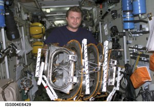 ISS004-E-6429 (January 2002) --- Cosmonaut Yury I. Onufrienko, Expedition Four mission commander representing Rosaviakosmos, works with equipment in the Zvezda Service Module on the International Space Station (ISS). The image was taken with a digital still camera.