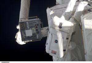 ISS004-E-8043 (20 February 2002) --- Astronaut Daniel W. Bursch, Expedition Four flight engineer, participates in the five-hour, 47-minute space walk on February 20, 2002. He moves among the oxygen and nitrogen tanks on the exterior of Quest Airlock. The square device (left) on the Space Station Remote Manipulator System (SSRMS) or Canadarm2 is the Materials International Space Station Experiment (MISSE). The image was recorded with a digital still camera.