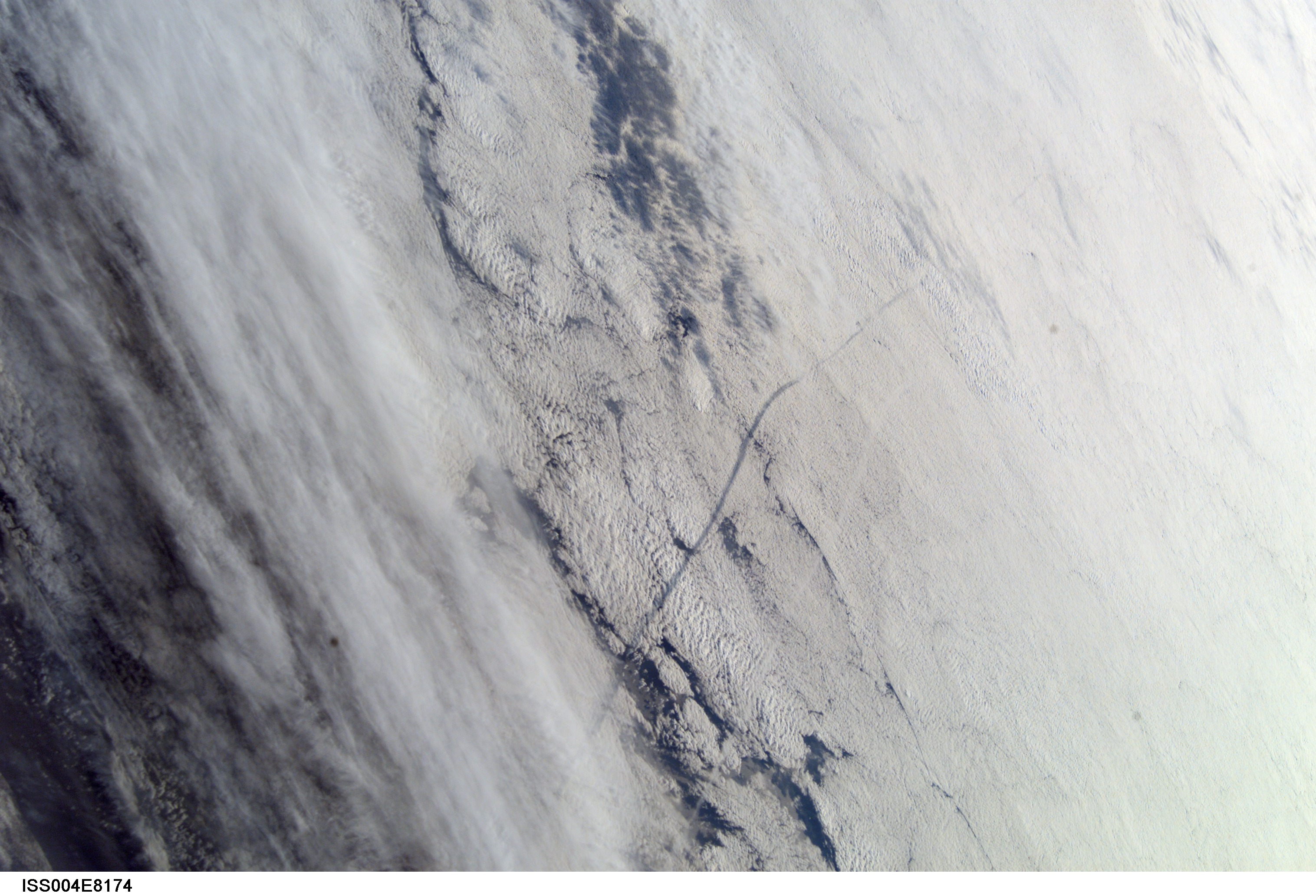 ISS004-E-8174 (1 March 2002) --- This image of Columbia's STS-109 launch plume was taken by the Expedition Four crew using a digital still camera on board the International Space Station. The space station crew shot this photograph as the station flew high over the Atlantic Ocean moments before Columbia's liftoff. The shuttle's plume is visible in the right side of this image, and the plume's shadow is reflected off the clouds to the left.