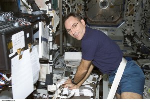 ISS004-E-8510 (11 March 2002) --- Astronaut Carl E. Walz, Expedition Four flight engineer, performs cardio-pulmonary resuscitation (CPR) on a jerry-rigged “human chest” dummy in the Destiny laboratory on the International Space Station (ISS). The image was taken with a digital still camera.