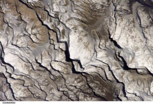 ISS004-E-8852 (20 March 2002) --- Astronaut Daniel W. Bursch, flight engineer for Expedition Four aboard the International Space Station, used a digital still camera to capture this image of Mt. Everest in the Himalayan Range. The mountain is near frame center. Here are the notes Bursch added in one of his reports to ground controllers: "One morning I happened to be up early. I glanced at our world map and saw that we’d be passing near Mt Everest soon. I checked the computer, realized that we were in an attitude that would allow me to open the window shutter and there was Mt Everest! It almost seemed to jump out at me. The low sun angle (it was close to orbital sunrise) gave tremendous relief to the mountains. It was just one of those sights that will be forever burned into my brain!"