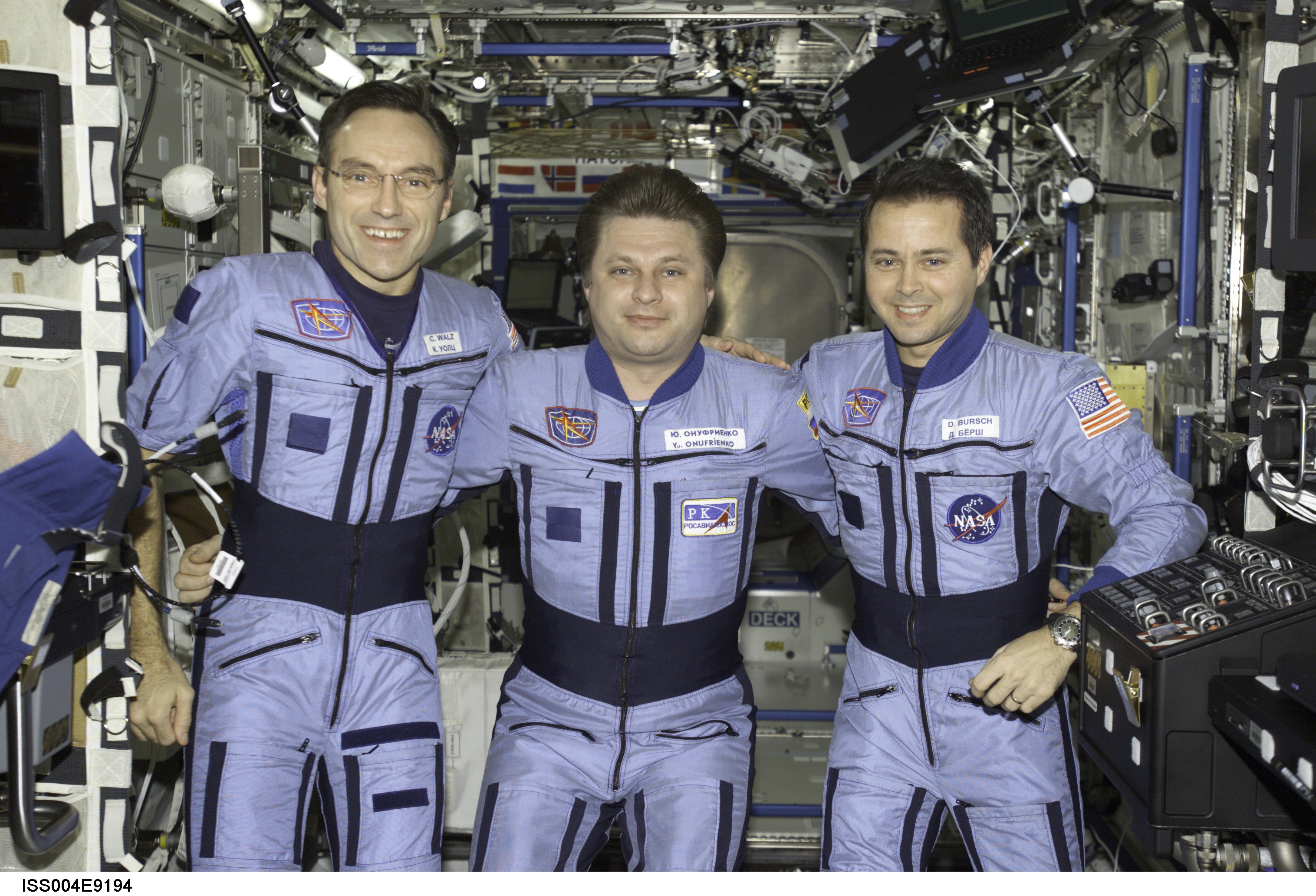 ISS004-E-9194 (23 March 2002) --- The Expedition Four crewmembers pose for an informal crew photo in the Destiny laboratory on the International Space Station (ISS). From the left are astronaut Carl E. Walz, flight engineer, cosmonaut Yury I. Onufrienko, mission commander, and astronaut Daniel W. Bursch, flight engineer. Onufrienko represents Rosaviakosmos. The image was taken with a digital still camera.