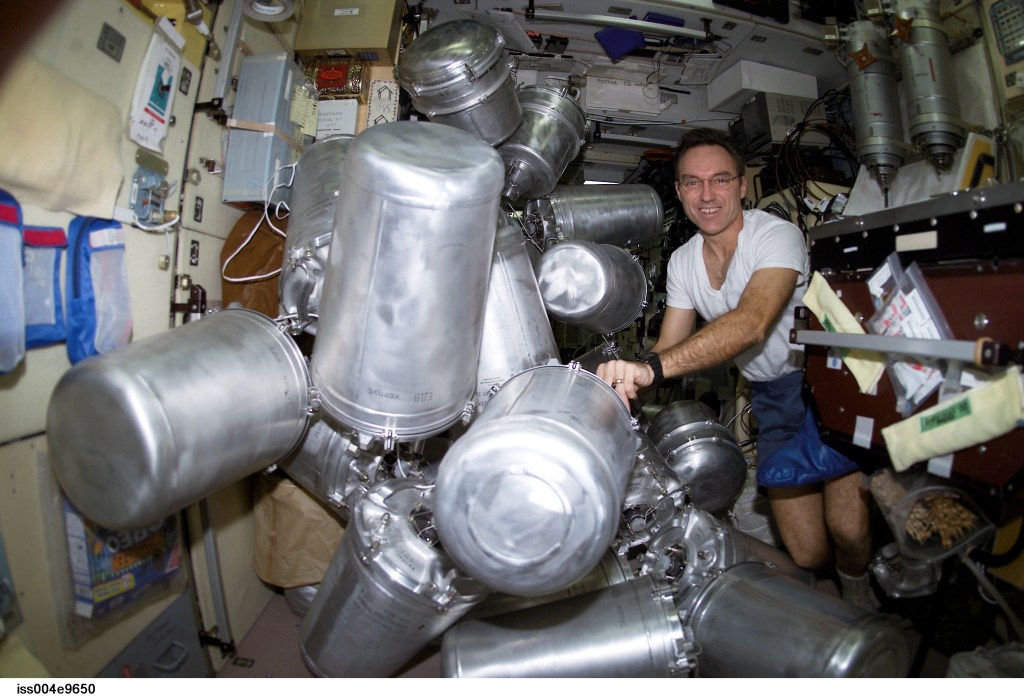 ISS004-E-9650 (11 March 2002) --- Astronaut Carl E. Walz, Expedition Four flight engineer, catalogs canisters of water in the Zvezda Service Module on the International Space Station (ISS).