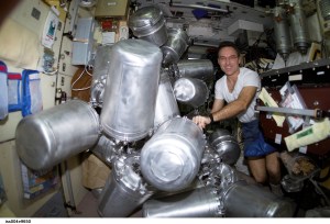 ISS004-E-9650 (11 March 2002) --- Astronaut Carl E. Walz, Expedition Four flight engineer, catalogs canisters of water in the Zvezda Service Module on the International Space Station (ISS).