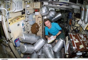 ISS004-E-9651 (11 March 2002) --- Cosmonaut Yury I. Onufrienko, Expedition Four mission commander, catalogs canisters of water in the Zvezda Service Module on the International Space Station (ISS).