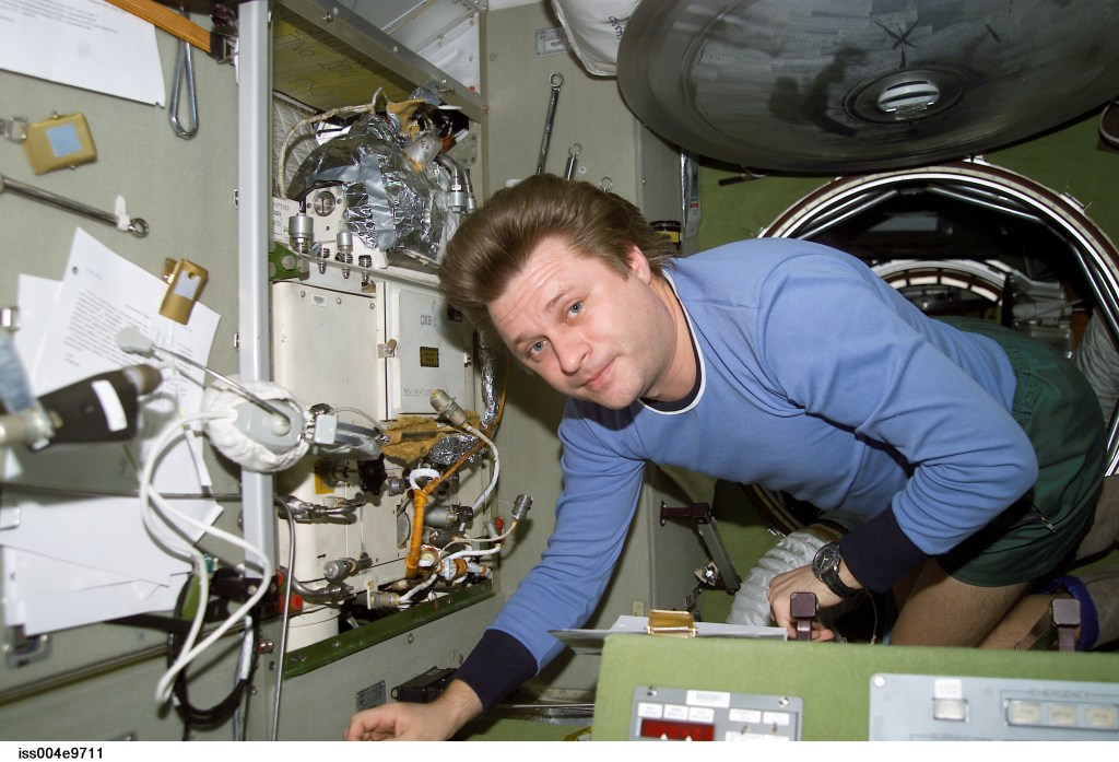 ISS004-E-9711 (3 April 2002) --- Cosmonaut Yury I. Onufrienko, Expedition Four mission commander, works in the Zvezda Service Module on the International Space Station (ISS).