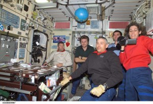 ISS004-E-9967 (10 April 2002) --- Astronauts Lee M. E. Morin (left foreground) and Ellen Ochoa, both STS-110 mission specialists; along with astronaut Stephen N. Frick (left background), STS-110 pilot, cosmonaut Yury I. Onufrienko, Expedition Four mission commander, and astronaut Rex J. Walheim, STS-110 mission specialist, are photographed in the Zvezda Service Module on the International Space Station (ISS).