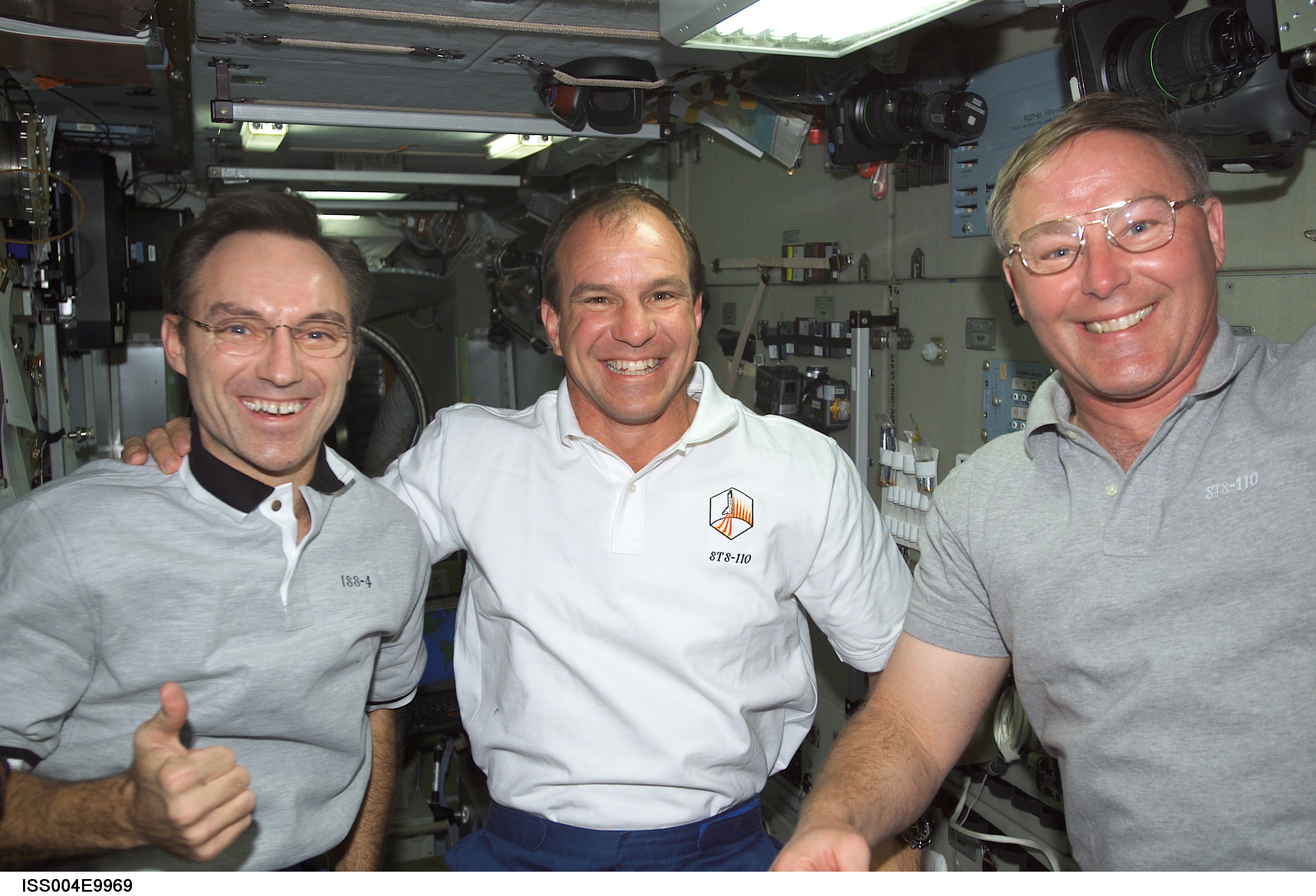 ISS004-E-9969 (10 April 2002) --- Astronauts Carl E. Walz (left), Expedition Four flight engineer, Michael J. Bloomfield and Jerry L. Ross, STS-110 mission commander and mission specialist, respectively, are photographed in the Zvezda Service Module on the International Space Station (ISS).
