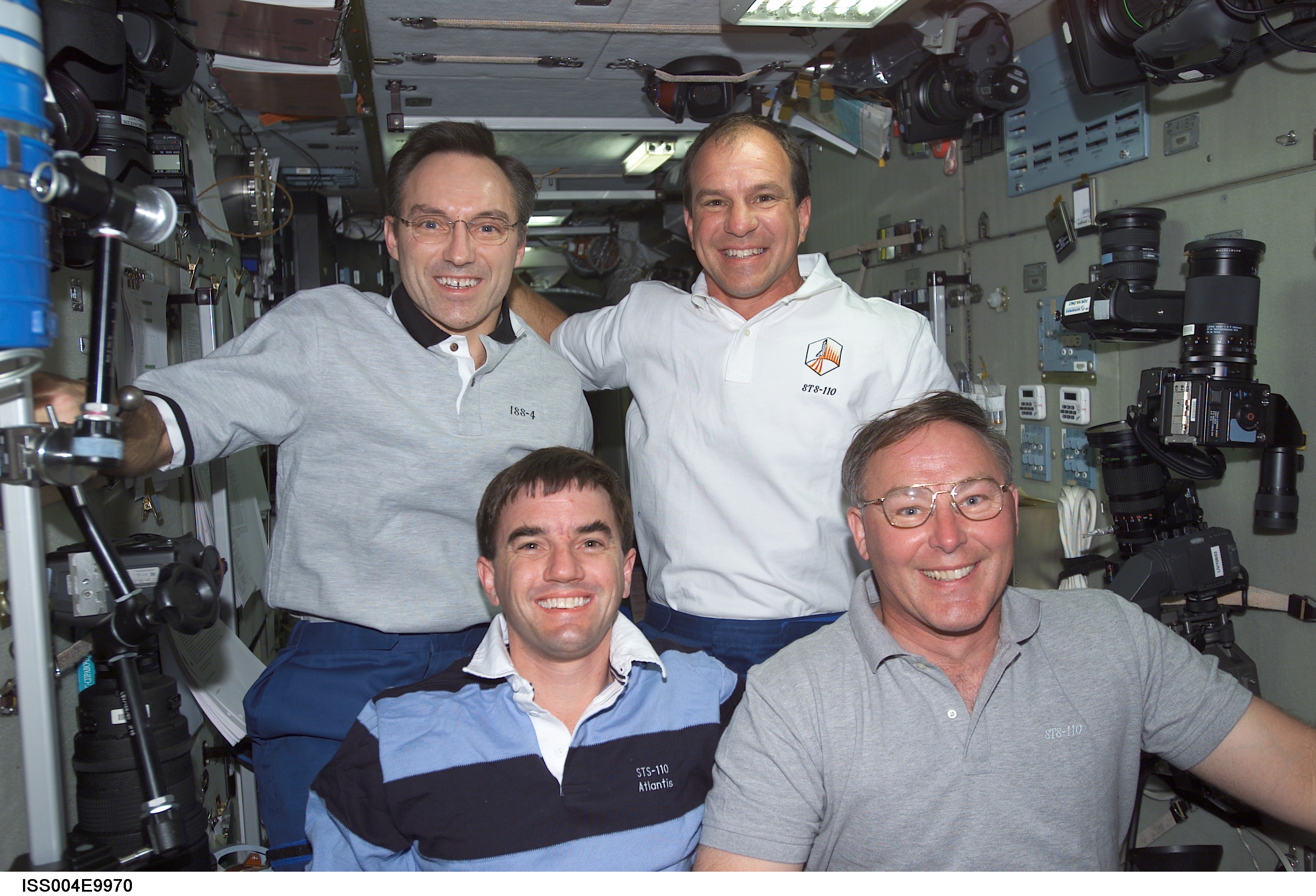 ISS004-E-9970 (10 April 2002) --- Astronauts Rex J. Walheim (bottom left), Jerry L. Ross, both STS-110 mission specialists, Carl E. Walz (top left) and Michael J. Bloomfield, Expedition Four flight engineer and STS-110 mission commander, respectively, gather for a group photo in the Zvezda Service Module on the International Space Station (ISS).
