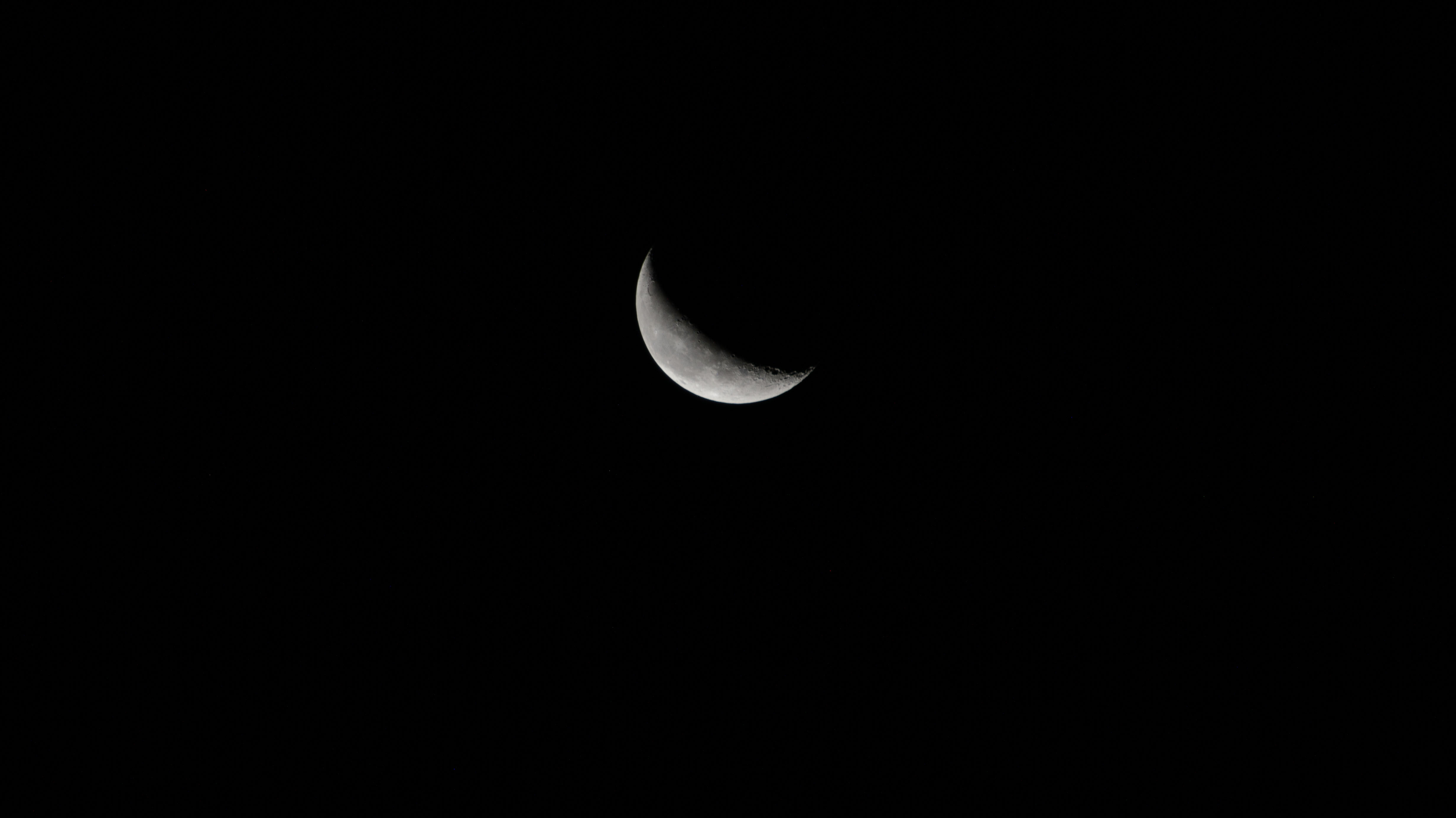 iss072e116495 (Oct. 26, 2024) -- A waning crescent moon hangs against the deep black of space as the International Space Station orbited 258 miles above the North Pacific Ocean.