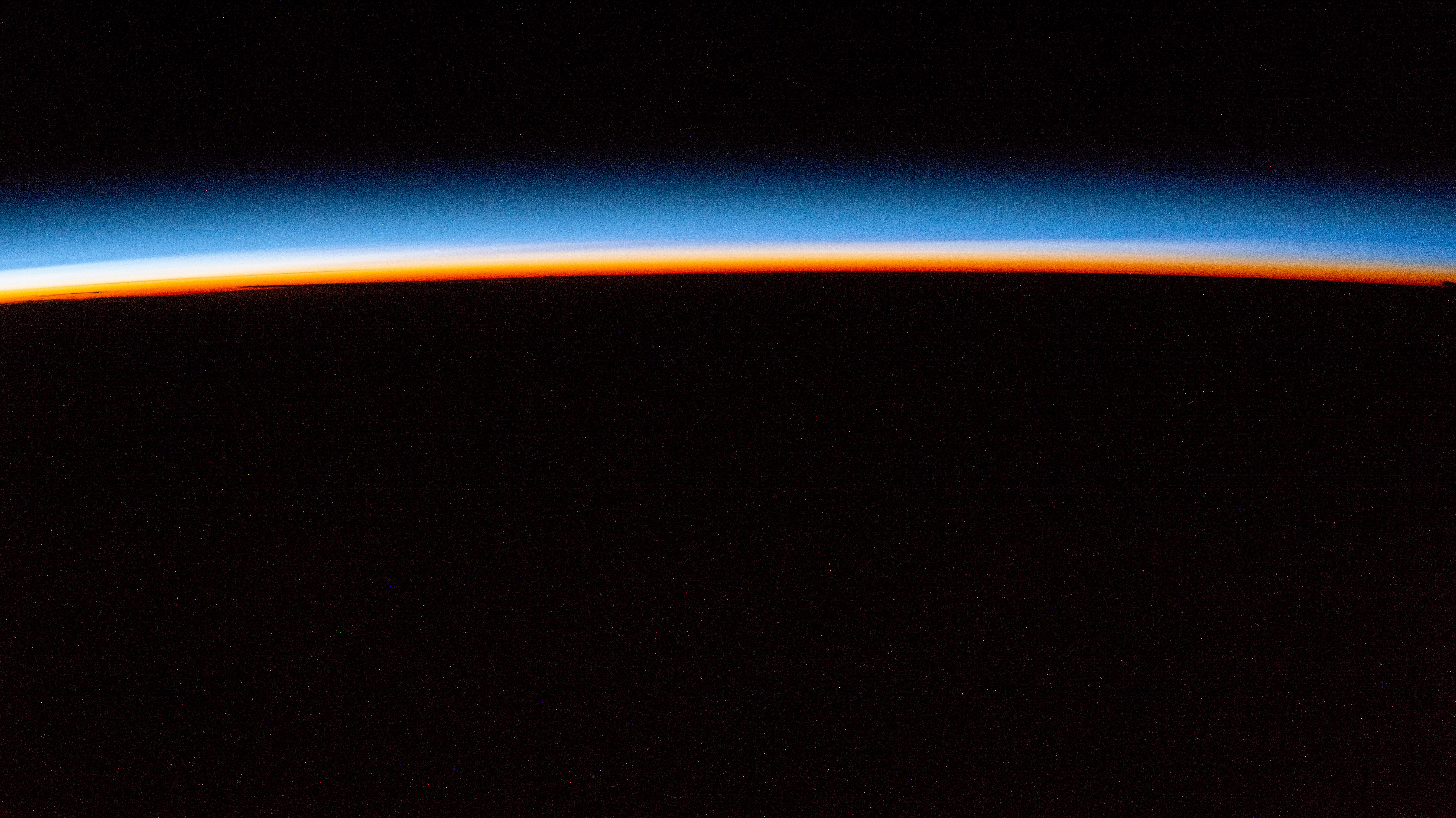 iss072e143829 (Nov. 2, 2024) -- The first rays of an orbital sunrise display pink and blue hues in Earth's atmosphere as the International Space Station orbited 257 miles above Austria.