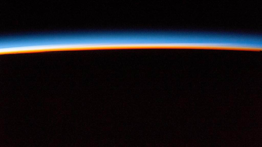 iss072e143829 (Nov. 2, 2024) -- The first rays of an orbital sunrise display pink and blue hues in Earth's atmosphere as the International Space Station orbited 257 miles above Austria.