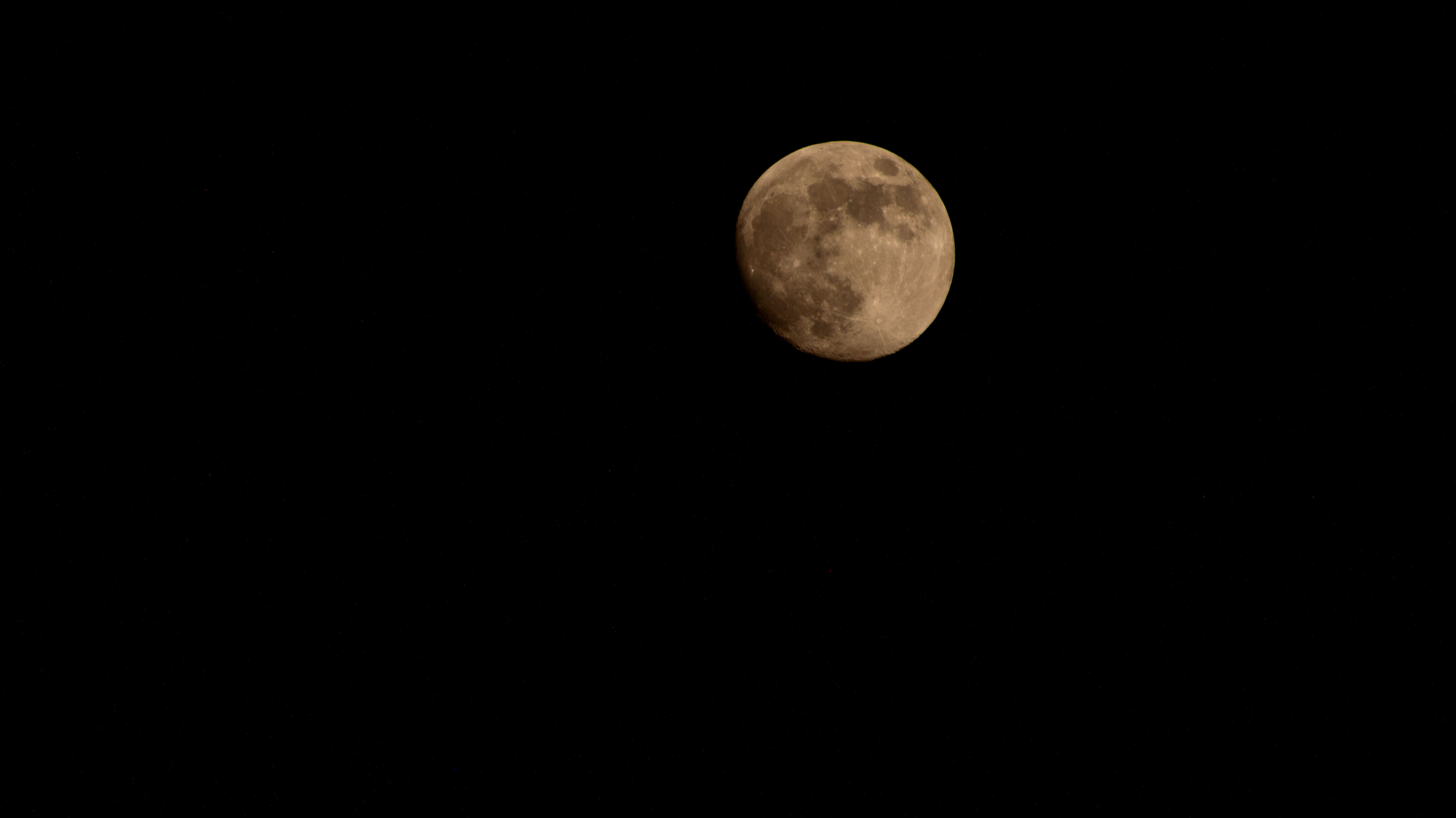 iss072e186908 (Nov. 14, 2024) -- A golden waxing gibbous moon is pictured from the International Space Station as it orbited 259 miles above Earth.