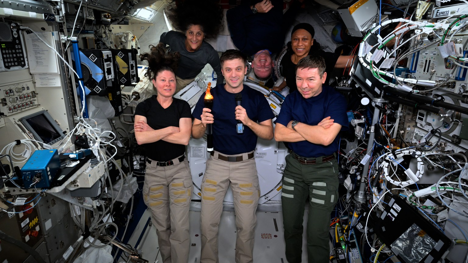 NASA astronauts, as part of Expedition 71, pose for a portrait during their ISS "Olympics" games.