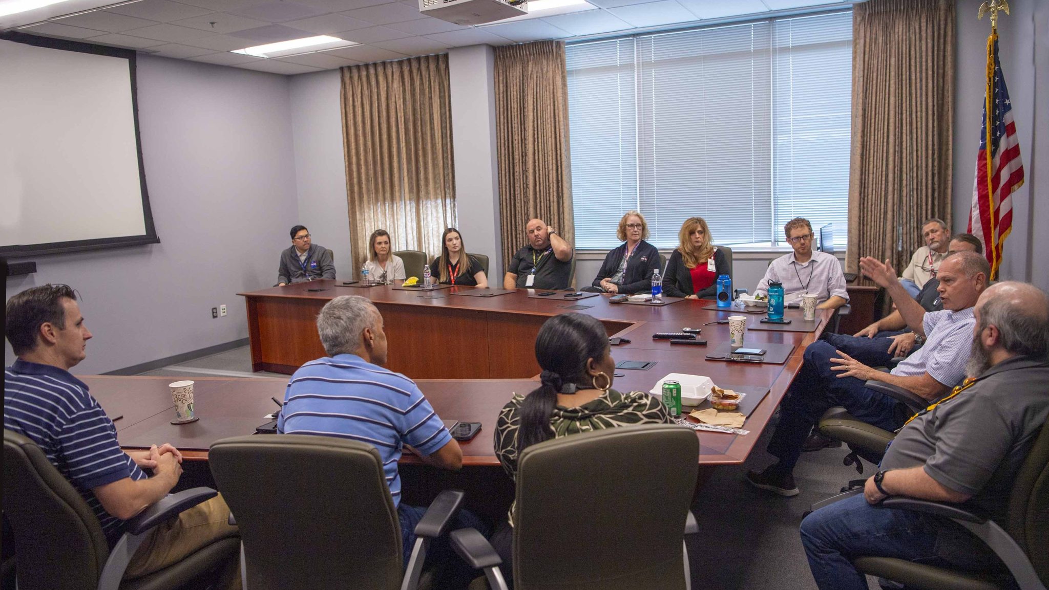 a small group of NASA Stennis employees meet with NASA Stennis Director John Bailey