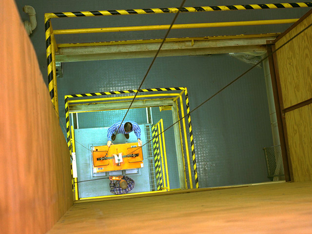View from the eighth floor as technicians ready the drag shield assembly