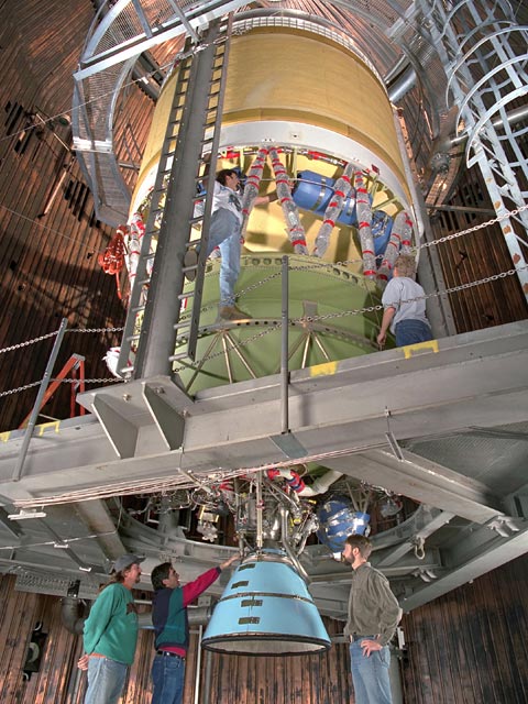 Technicians prepare a full-scale upper stage rocket engine