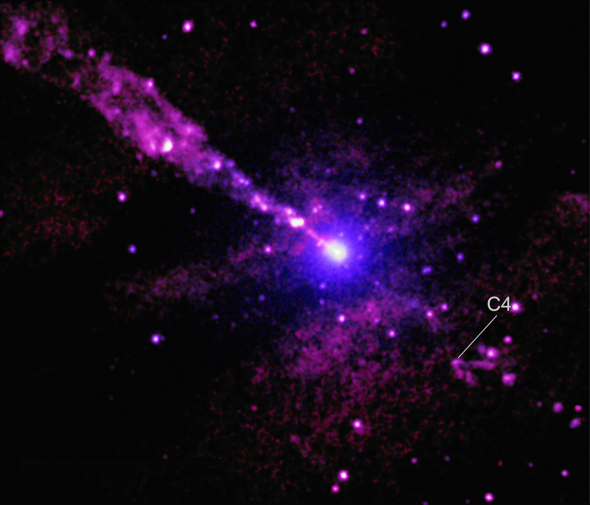 Using the deepest X-ray image ever made with Chandra of Centaurus A, astronomers have found an unusual mark from the giant black hole’s powerful jet striking an unidentified object in its path. A patch of V-shaped emission connected to a bright source of X-rays is located close to the path of the jet from the supermassive black hole (highlighted in the inset). The arms of the “V” are at least about 700 light-years long. In this image, low, medium, and high-energy X-rays from Chandra are colored pink, purple, and blue respectively.