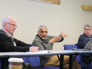 A man sits at a table during a group discussion and discusses his idea. Photo taken at the 2025 workshop Emerging Technologies for Astrophysics Missions, held at NASA Ames Research Center.