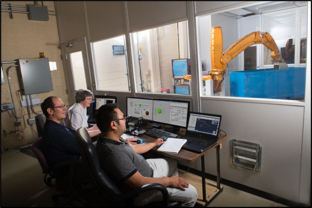 Operators control the Advanced Planetary Excavator outside of dust enclosure using LabVIEW software