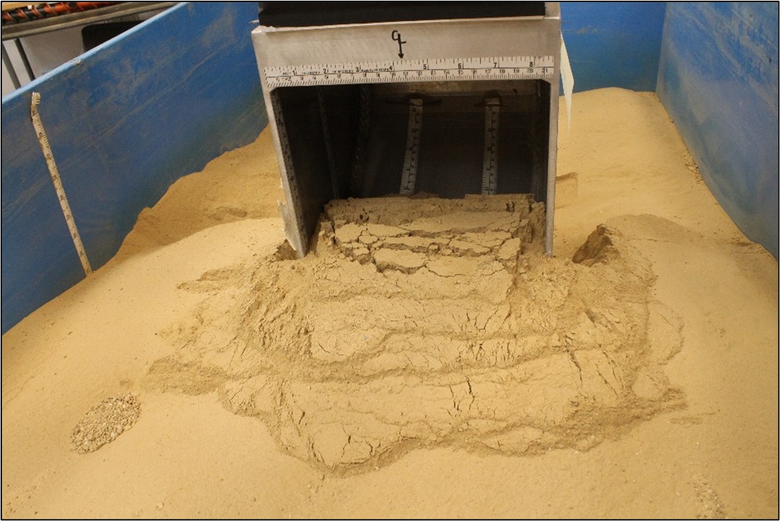 Bow wake of soil in front of the Advanced Planetary Excavator bucket in compacted GRC-3B lunar soil simulant