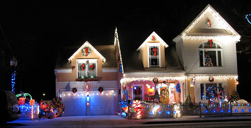 an illuminated single family home, decorated in holiday lights