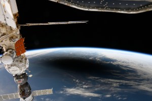 The image above, taken as the space station orbited over 250 miles above the North Atlantic, shows the eclipse’s dark shadow from the Moon on Earth’s surface surrounded by white clouds. Along the top edge of the planet, Earth’s bright horizon shines at the boundary between the atmosphere and space.